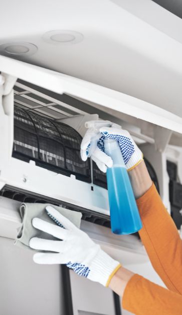 Woman-cleaning-aircon-filter